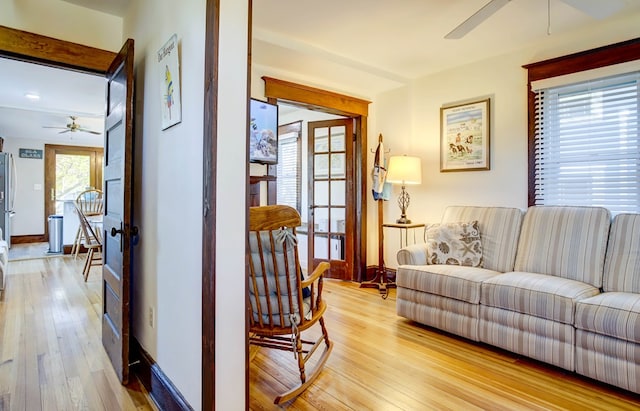 living room featuring light hardwood / wood-style flooring and ceiling fan