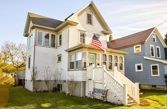 rear view of house with a yard