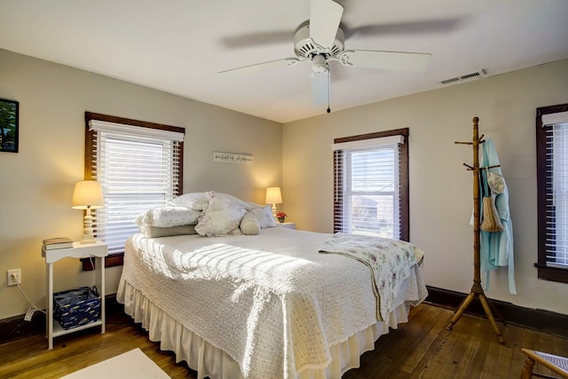 bedroom with ceiling fan and dark hardwood / wood-style floors