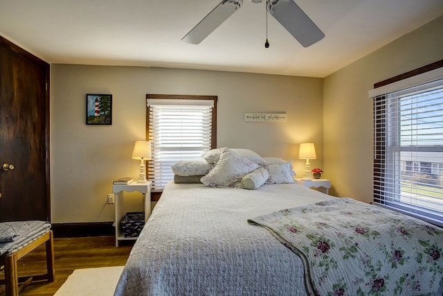 bedroom with ceiling fan and dark hardwood / wood-style flooring