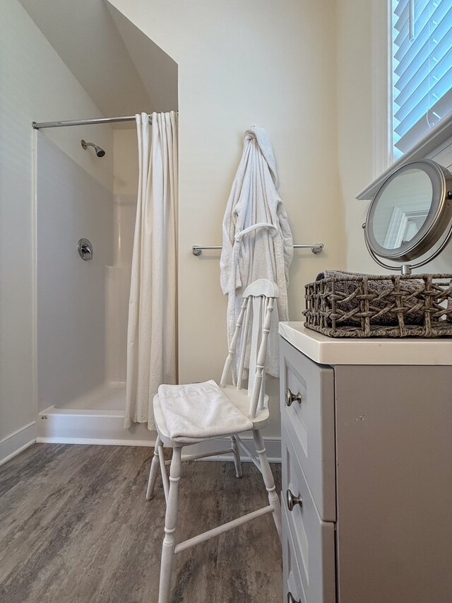614 Strawberry St, Cape Charles, VA 23310 - bathroom with wood finished floors, curtained shower, and vanity