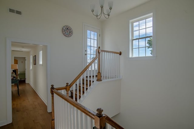 614 Strawberry St, Cape Charles, VA 23310 - staircase with wood finished floors and a chandelier