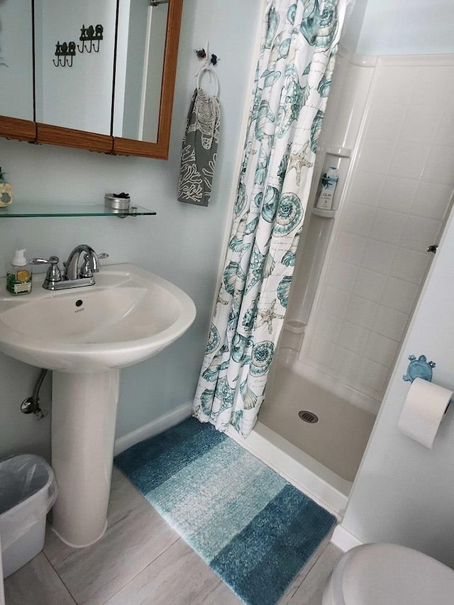 bathroom featuring a shower with shower curtain, sink, toilet, and hardwood / wood-style floors