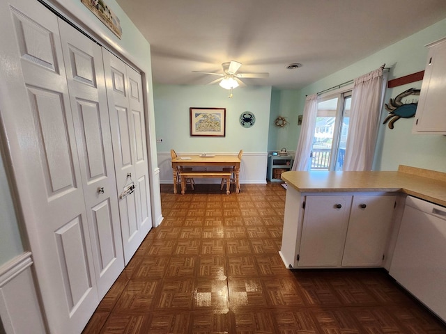 kitchen featuring white cabinetry, ceiling fan, dark parquet floors, kitchen peninsula, and white dishwasher