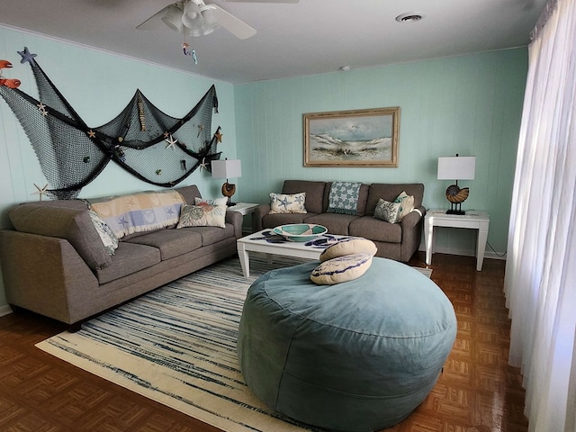 living room with dark parquet flooring and ceiling fan