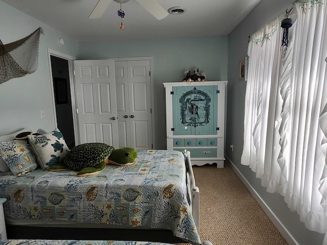 bedroom featuring multiple windows, ceiling fan, a closet, and carpet floors