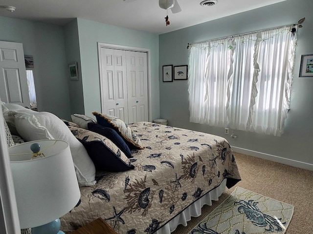 bedroom with ceiling fan, a closet, and carpet