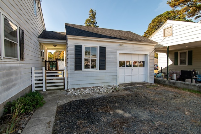 11510 Poplar Ave, Exmore, VA 23350 - view of front facade featuring a garage, a shingled roof, and driveway