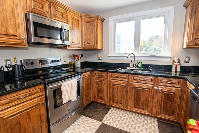 11510 Poplar Ave, Exmore, VA 23350 - kitchen featuring appliances with stainless steel finishes, brown cabinetry, and dark stone countertops