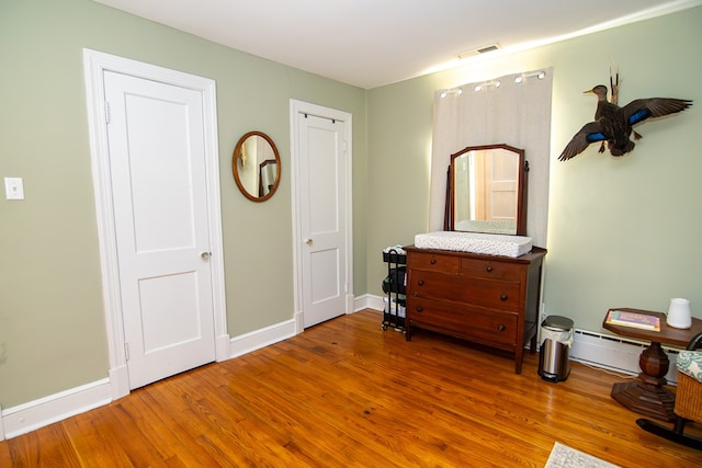 11510 Poplar Ave, Exmore, VA 23350 - bedroom with wood finished floors and baseboard heating