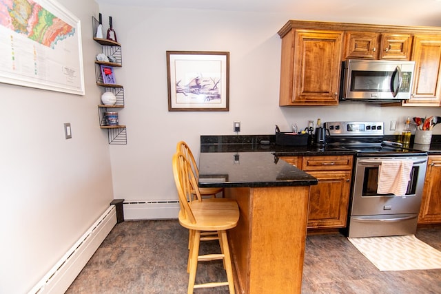 11510 Poplar Ave, Exmore, VA 23350 - kitchen with stainless steel appliances, a baseboard radiator, a peninsula, a kitchen breakfast bar, and brown cabinetry