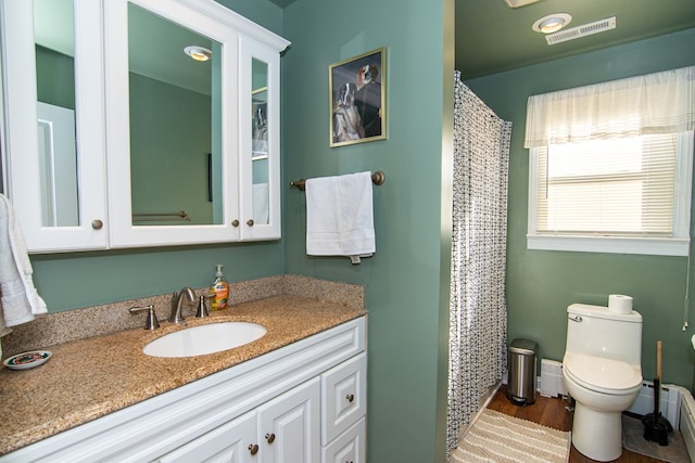 11510 Poplar Ave, Exmore, VA 23350 - bathroom featuring vanity, wood finished floors, and a baseboard heating unit