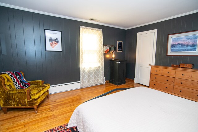 11510 Poplar Ave, Exmore, VA 23350 - bedroom with a baseboard radiator, wood finished floors, and ornamental molding