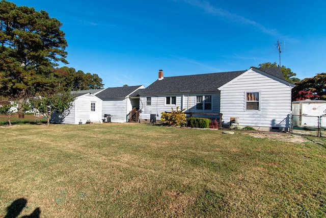 11510 Poplar Ave, Exmore, VA 23350 - back of property featuring a chimney, roof with shingles, and an outbuilding
