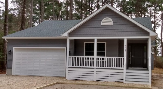 view of front of home with a porch and a garage