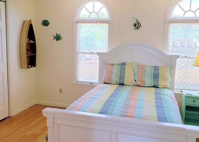 bedroom featuring multiple windows and light wood-type flooring