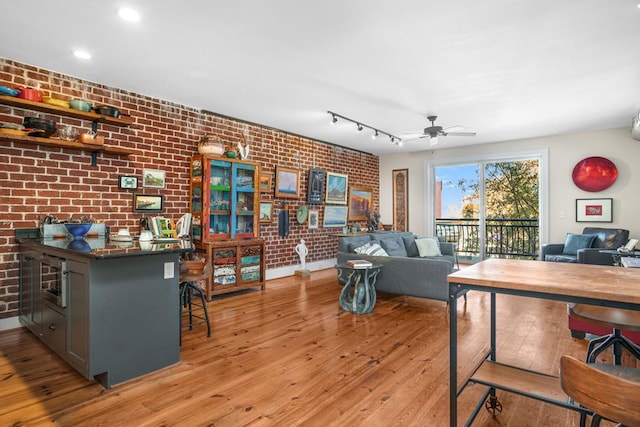 3002E Mason Ave, Cape Charles, VA 23310 - living area featuring brick wall, a ceiling fan, and light wood-type flooring