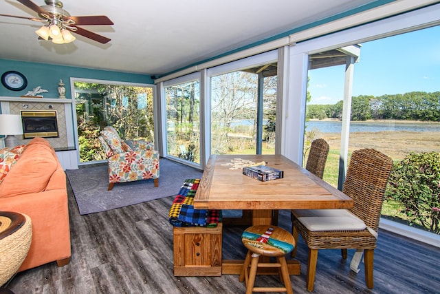 sunroom with a water view, wood finished floors, and plenty of natural light
