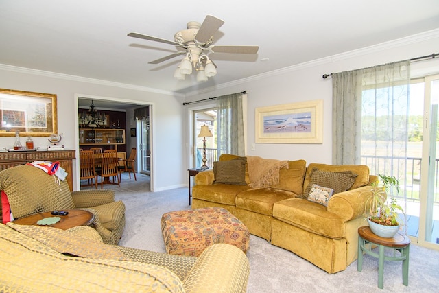 carpeted living room featuring baseboards, a ceiling fan, and crown molding