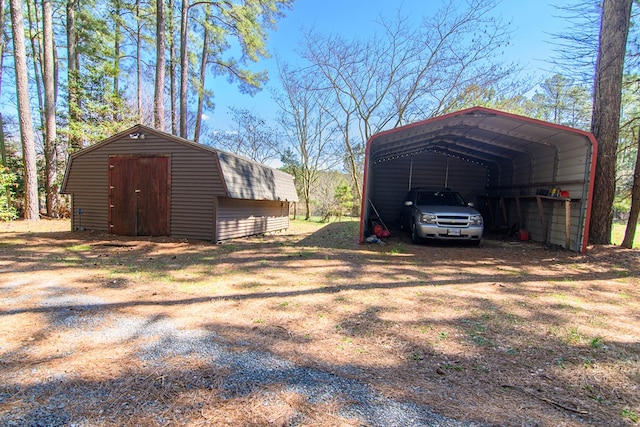 exterior space with an outdoor structure, a carport, and a storage shed
