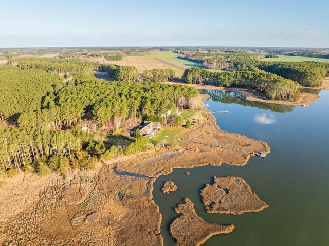 drone / aerial view featuring a water view and a wooded view