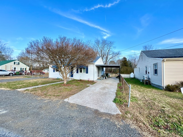 view of front of house with a front yard and a carport