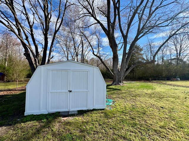 view of yard with a storage unit and a patio area