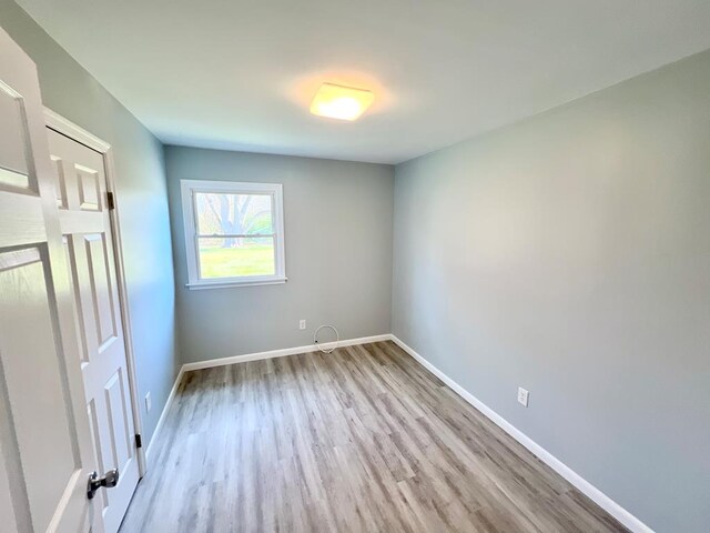 bedroom featuring multiple windows and light hardwood / wood-style floors