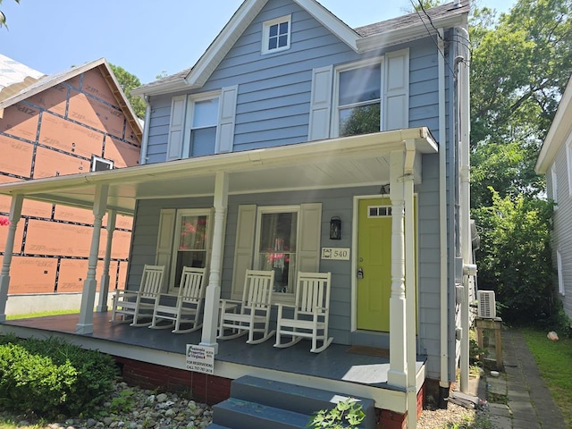 back of house featuring covered porch