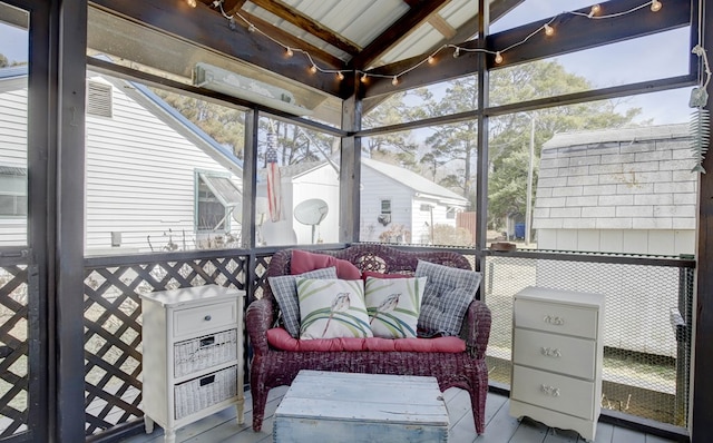 sunroom / solarium featuring vaulted ceiling