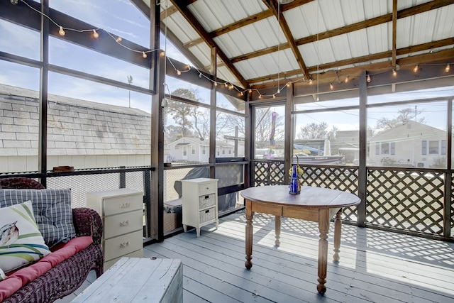 sunroom with a healthy amount of sunlight and vaulted ceiling