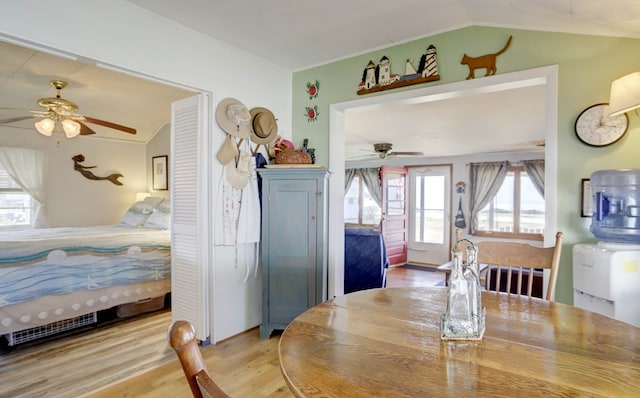 dining area featuring lofted ceiling, ceiling fan, wood finished floors, and visible vents