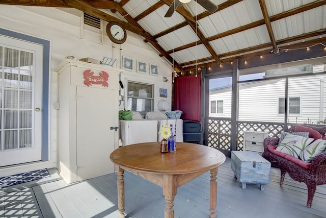 sunroom with lofted ceiling and ceiling fan