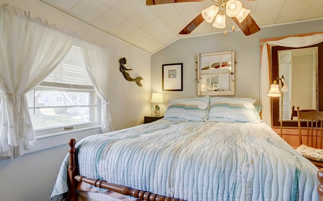 bedroom featuring lofted ceiling, a ceiling fan, and crown molding