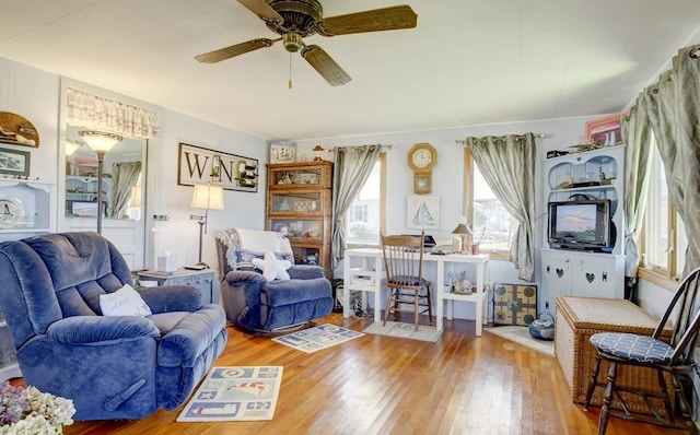 living room with wood finished floors and a ceiling fan