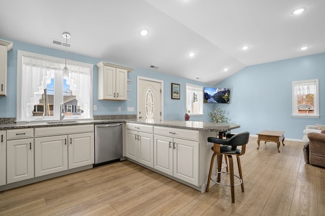 kitchen with visible vents, dishwasher, lofted ceiling, a peninsula, and light wood-type flooring