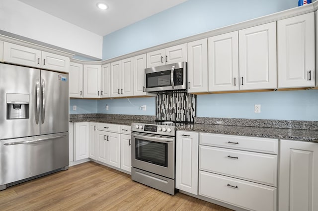 kitchen featuring light wood-style floors, appliances with stainless steel finishes, white cabinets, and recessed lighting