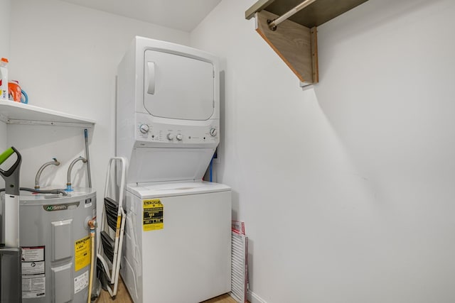 washroom with stacked washing maching and dryer, laundry area, and electric water heater