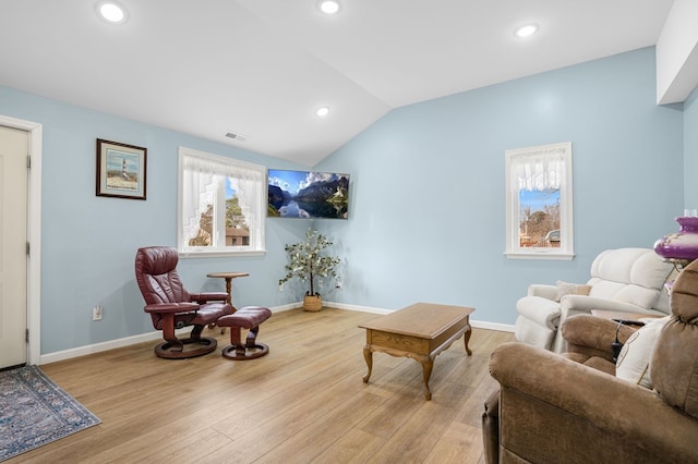 living area featuring lofted ceiling, baseboards, wood finished floors, and recessed lighting