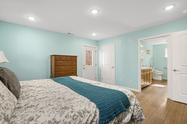 bedroom featuring baseboards, visible vents, wood finished floors, and recessed lighting