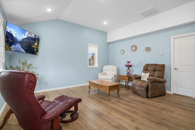 living area with baseboards, visible vents, lofted ceiling, wood finished floors, and recessed lighting