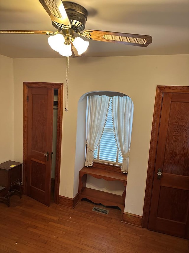 3533 Ridge Rd, Chincoteague, VA 23336 - unfurnished room with wood finished floors, ceiling fan, and baseboards
