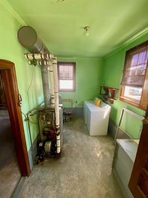 washroom with washer and dryer, ornamental molding, and laundry area