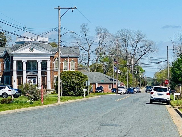 view of street with curbs, street lighting, and traffic signs