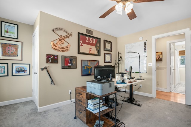 office area featuring baseboards, carpet floors, and a ceiling fan