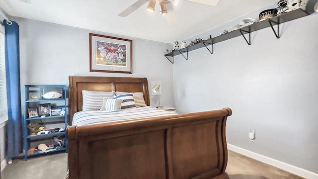 carpeted bedroom with ceiling fan and baseboards
