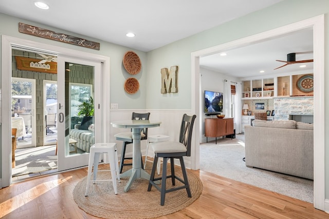 dining area with recessed lighting, a wainscoted wall, wood finished floors, and a ceiling fan