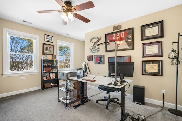 carpeted office featuring visible vents, a ceiling fan, and baseboards