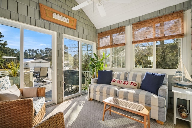sunroom with ceiling fan and vaulted ceiling