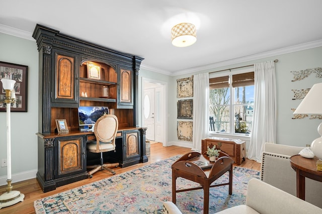 office area featuring light wood finished floors, baseboards, and ornamental molding